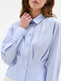 Camicia azzurra in cotone con pieghe cucite