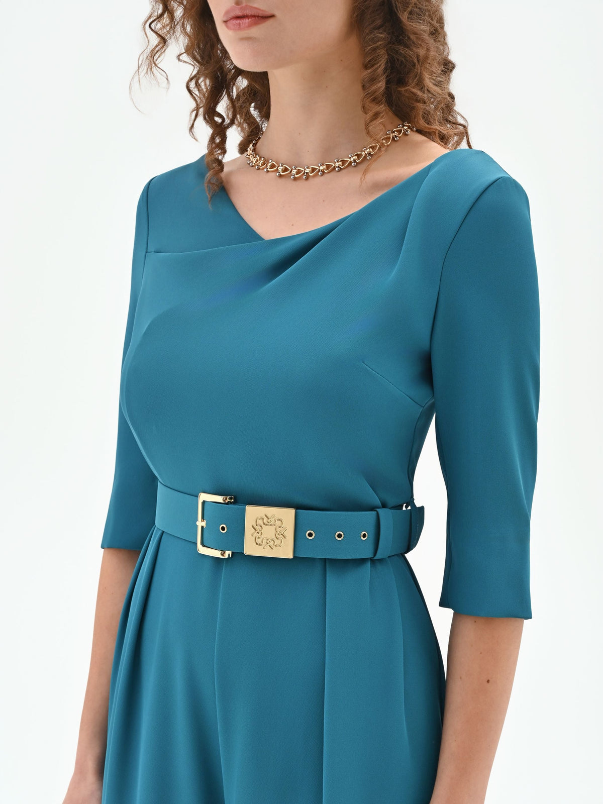 Tuta verde ottanio con scollo drappeggiato