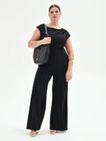 Tuta nera curvy con scollo asimmetrico