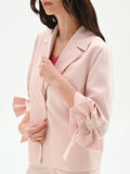 Giacca blazer rosa con fiocco sulla manica
