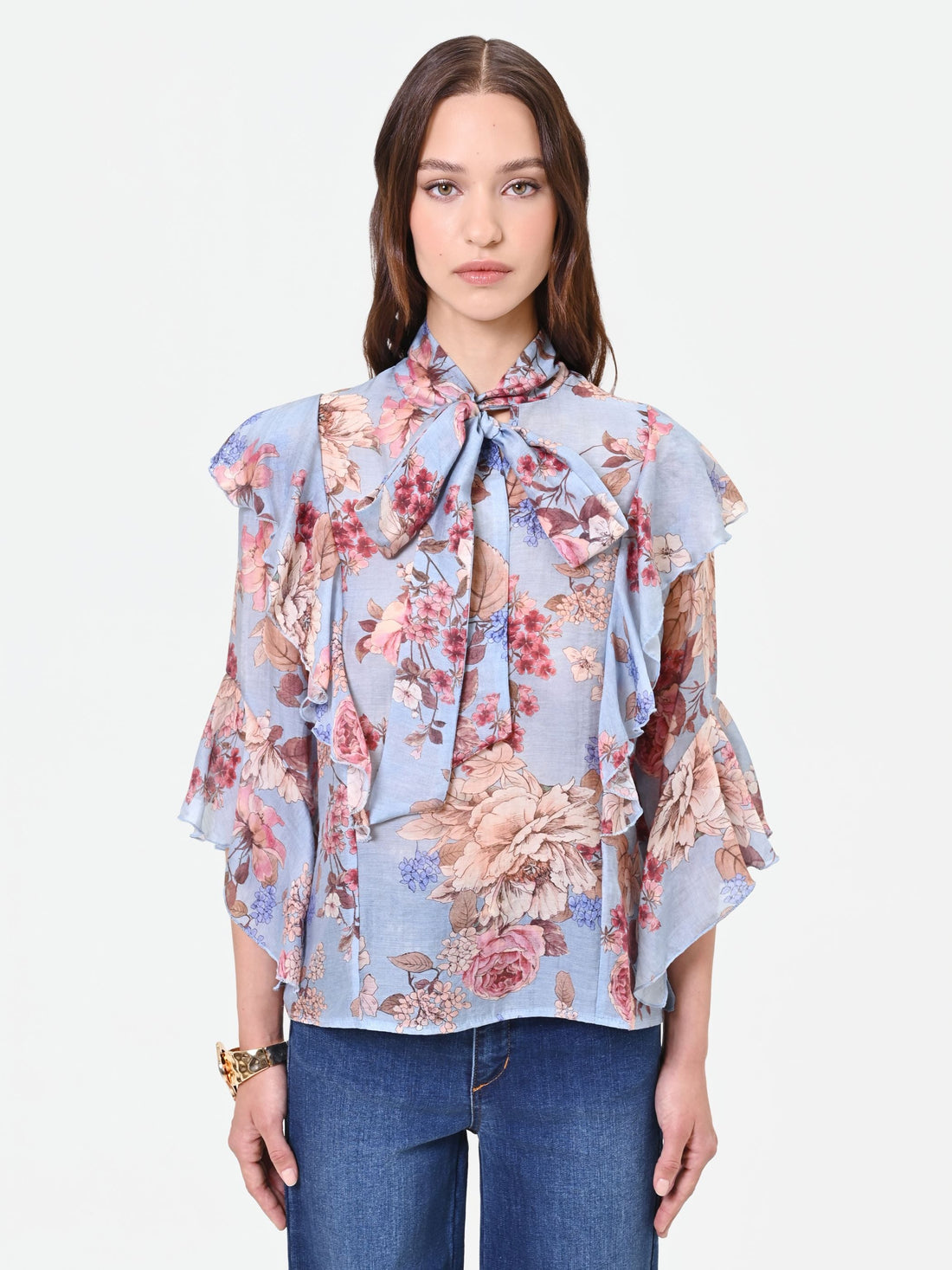 Blusa azzurra con fantasia floreale e fiocco