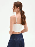 Top crop panna con maxi fiocco