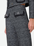 Pantalone nero in bouclé con tasche a toppa