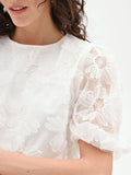 Blusa bianca in organza con maxi fiori applicati