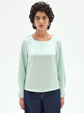 Blusa verde menta dalla linea essenziale