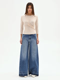 Blusa beige chiaro con drappeggio laterale