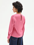 Blusa rosa con maniche a sbuffo