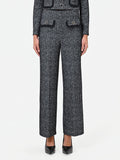 Pantalone nero in bouclé con tasche a toppa