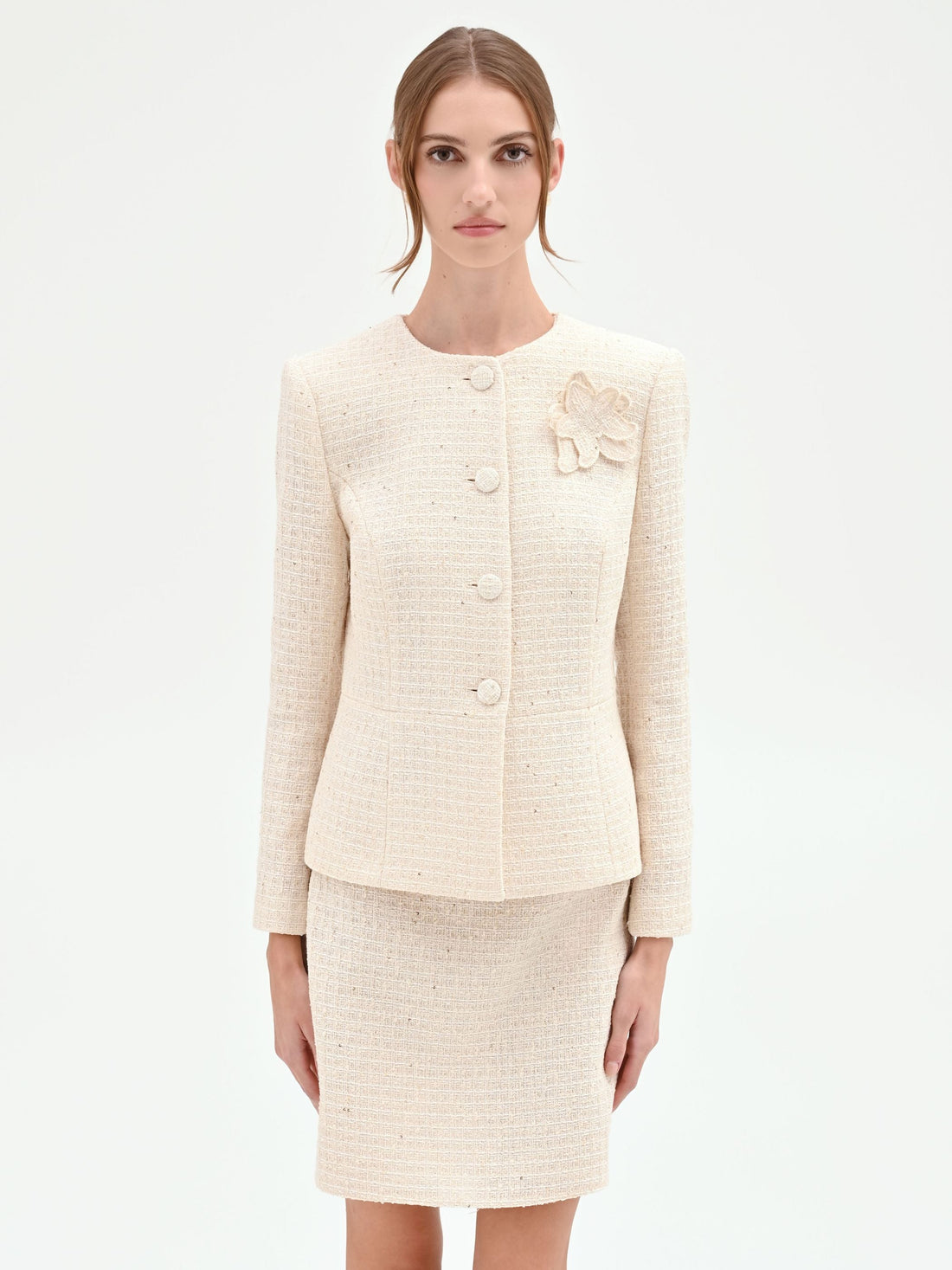 Giacca bouclé beige chiaro con fiore applicato