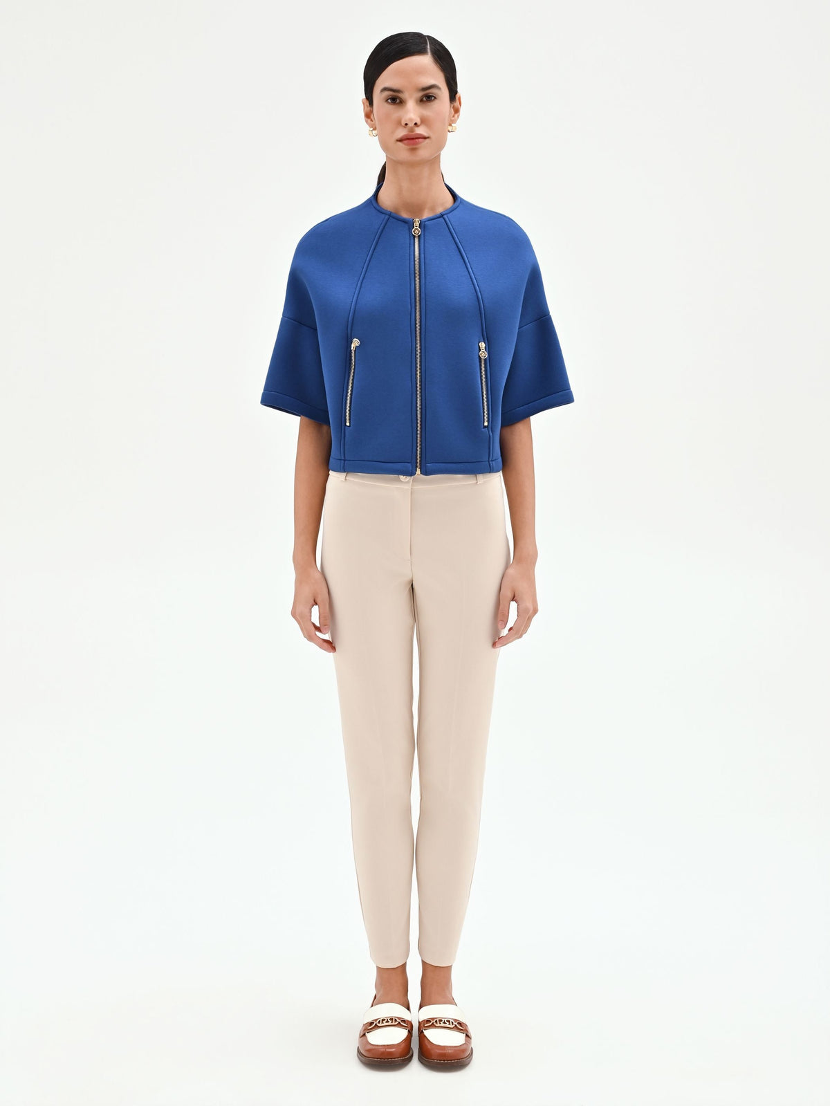 Capospalla cropped blu brillante con zip dorate