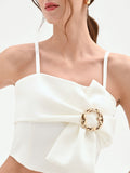 Top crop panna con maxi fiocco