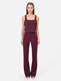 Pantalone svasato bordeaux in tessuto tecnico con fascione in vita