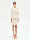 Giacca bouclé beige chiaro con fiore applicato