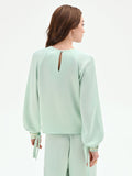 Blusa verde menta con pieghe e polsini alti
