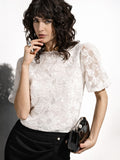 Blusa bianca in organza con maxi fiori applicati