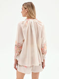 Blusa bianca con stampa floreale a rose