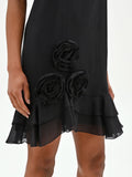 Mini abito nero in lyocell con rose applicate e balze