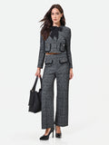 Pantalone nero in bouclé con tasche a toppa