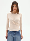 Blusa beige chiaro con drappeggio laterale