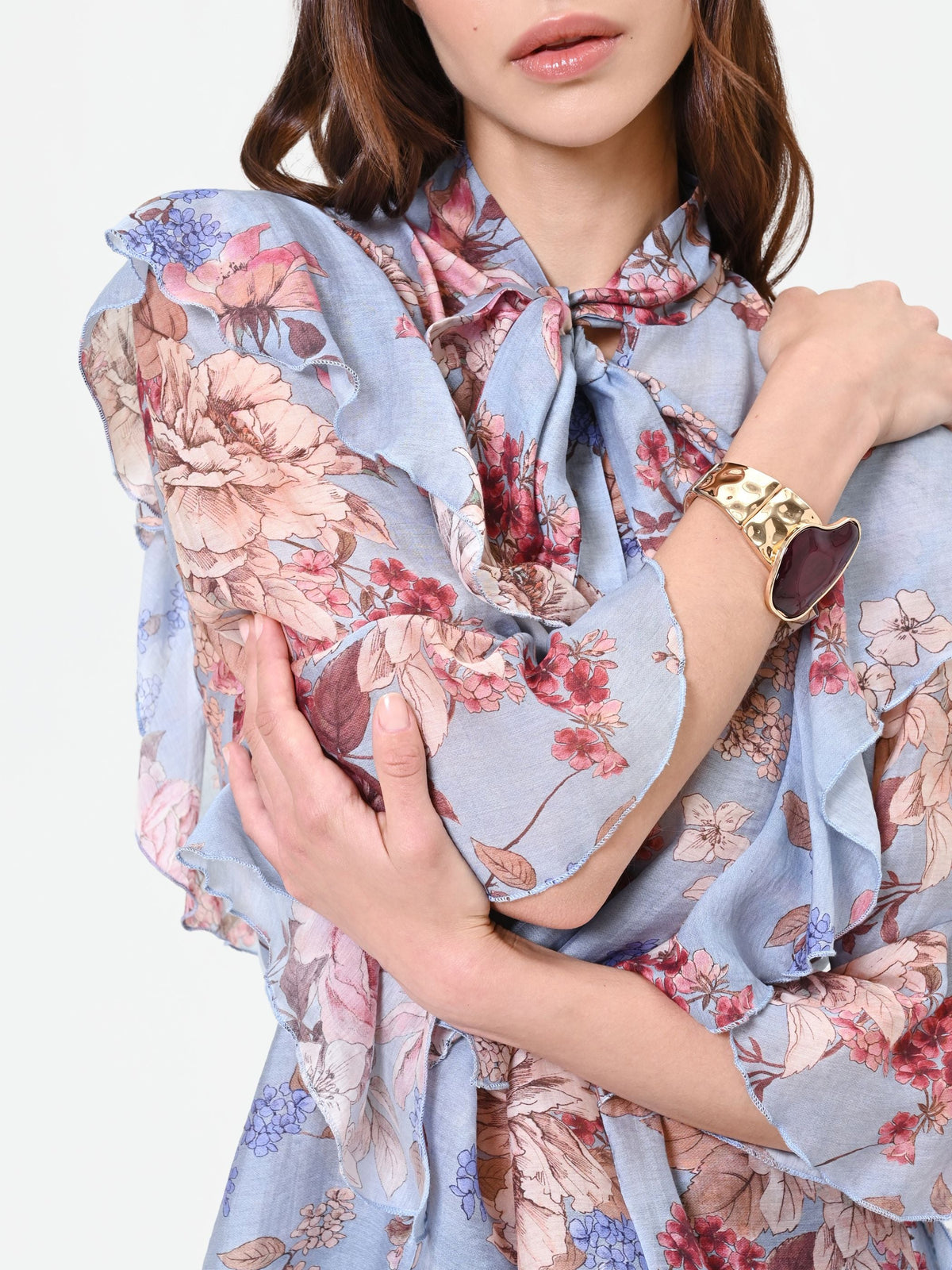 Blusa azzurra con fantasia floreale e fiocco