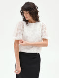 Blusa bianca in organza con maxi fiori applicati