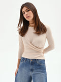 Blusa beige chiaro con drappeggio laterale