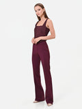 Pantalone svasato bordeaux in tessuto tecnico con fascione in vita