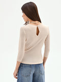Blusa beige chiaro con drappeggio laterale