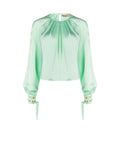 Blusa verde menta con pieghe e polsini alti