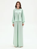 Blusa verde menta con pieghe e polsini alti